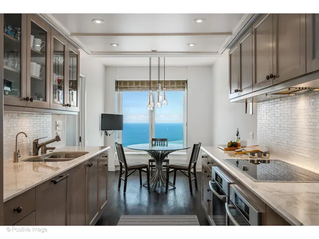 a kitchen with a table chairs stove and cabinets