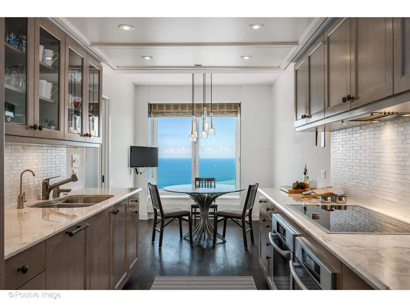 161 East Chicago Avenue, Unit 54A Chicago, IL 60611 - Photo 26 of 41 a kitchen with a table chairs stove and cabinets