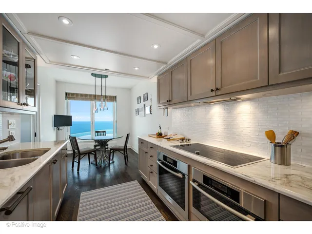 a kitchen with sink cabinets and wooden floor