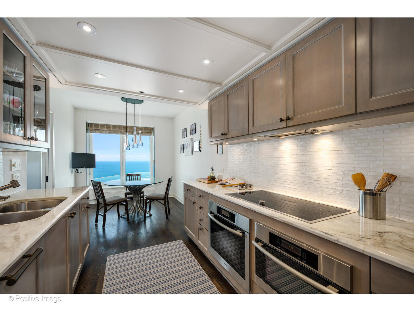 161 East Chicago Avenue, Unit 54A Chicago, IL 60611 - Photo 27 of 41 a kitchen with sink cabinets and wooden floor