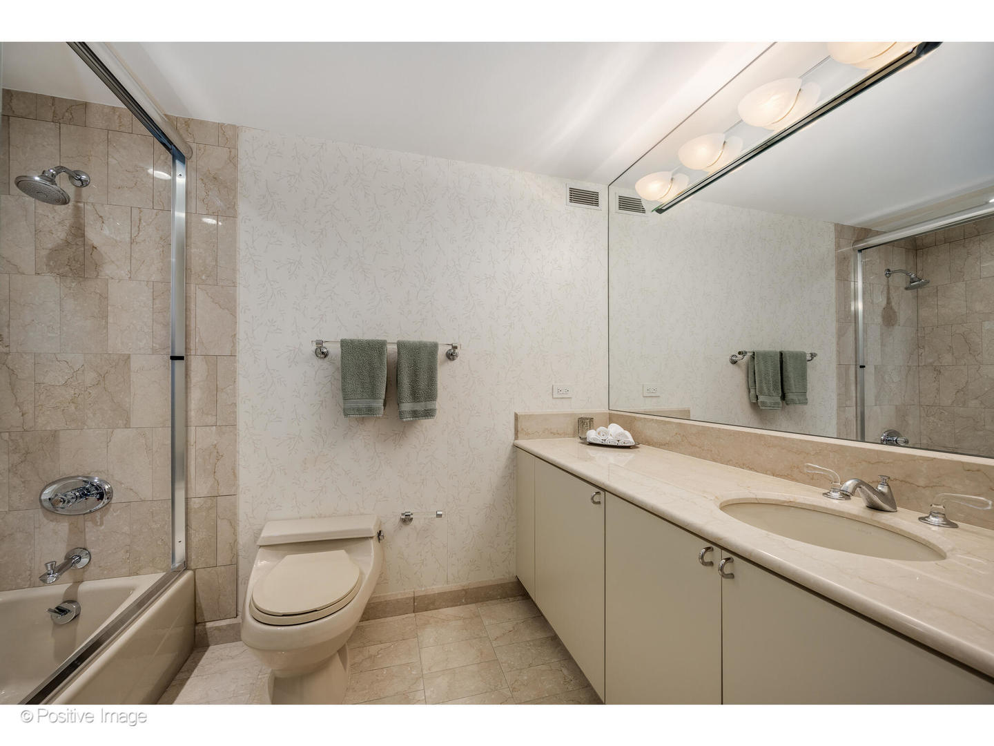 161 East Chicago Avenue, Unit 54A Chicago, IL 60611 - Photo 31 of 41 a bathroom with a sink a toilet a mirror and shower