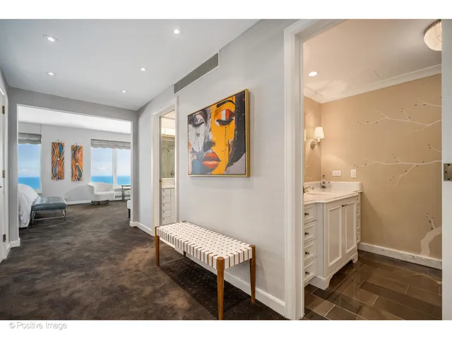 a bathroom with a sink a vanity and a painting