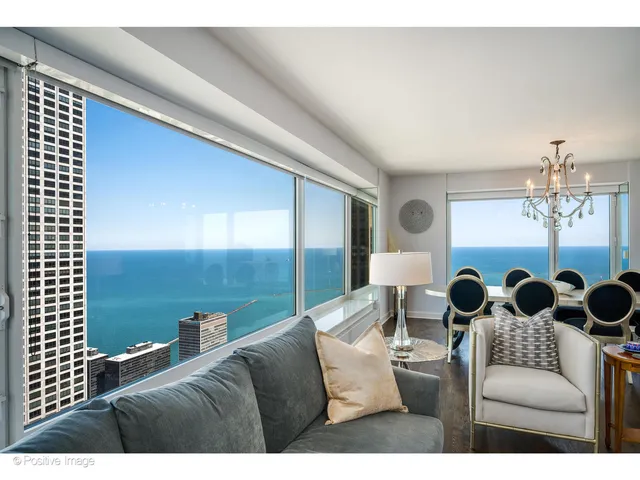 a living room with furniture and chandelier