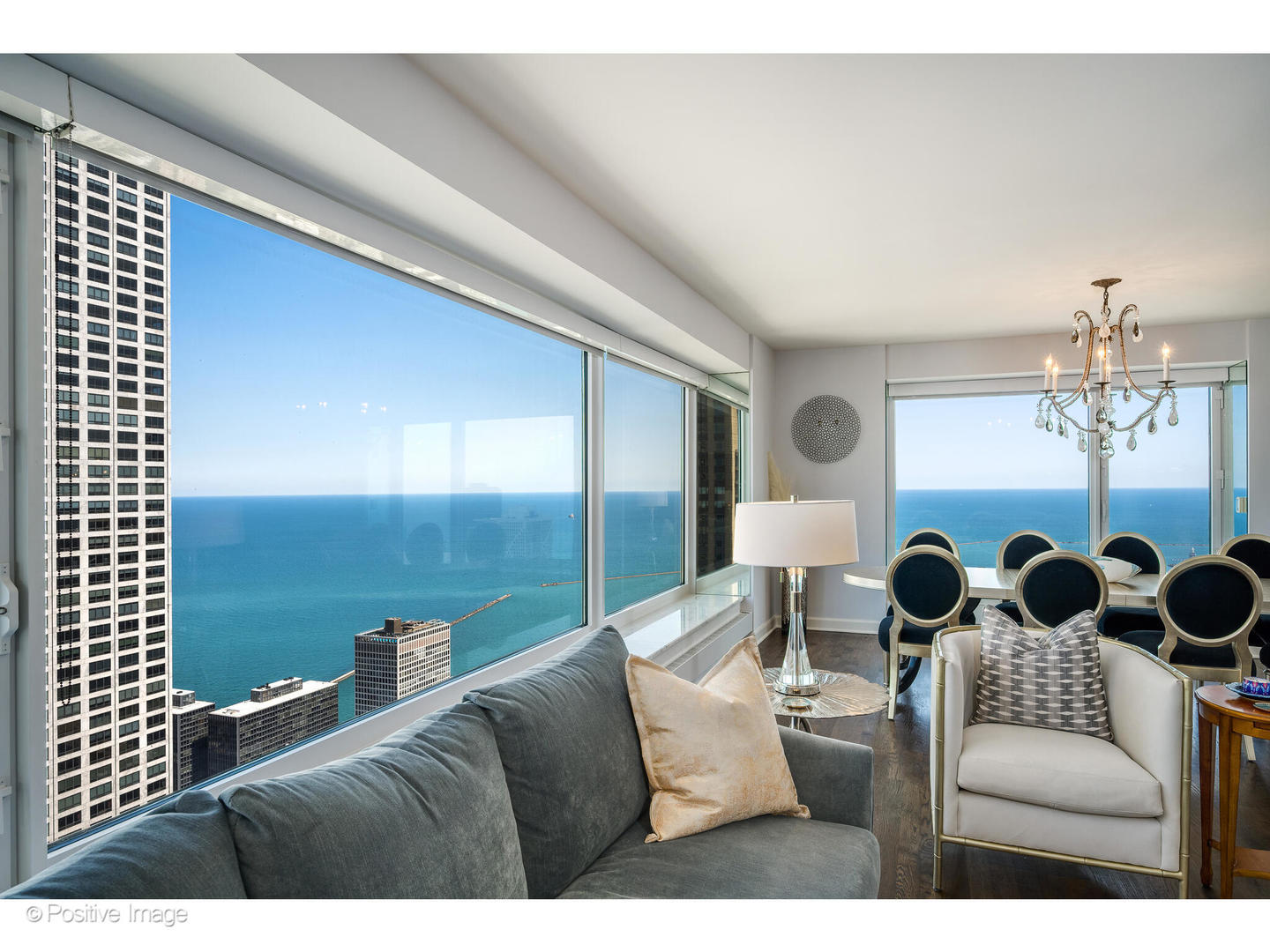 161 East Chicago Avenue, Unit 54A Chicago, IL 60611 - Photo 8 of 41 a living room with furniture and chandelier