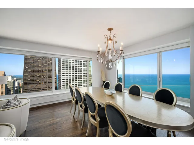 a view of a dining room with furniture and chandelier