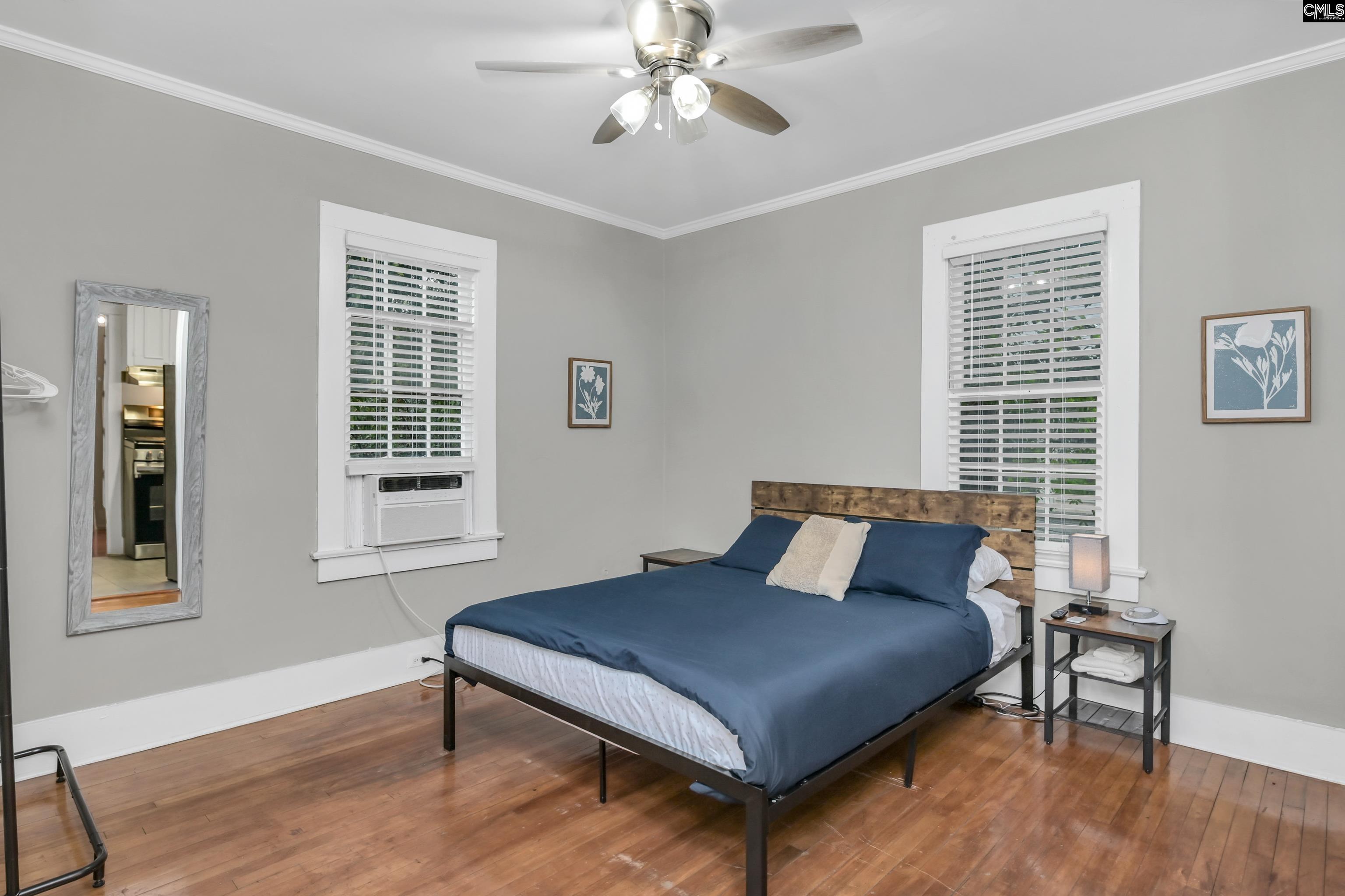 2227 Bull Street Columbia, SC 29201 - Photo 16 of 38 a bedroom with a bed window and wooden floor