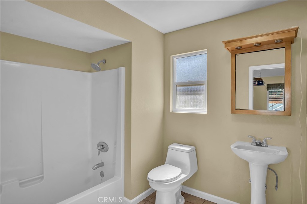 16410 Tish-A-Tang Road Lower Lake, CA 95457 - Photo 34 of 48 a bathroom with a sink and mirror with toilet