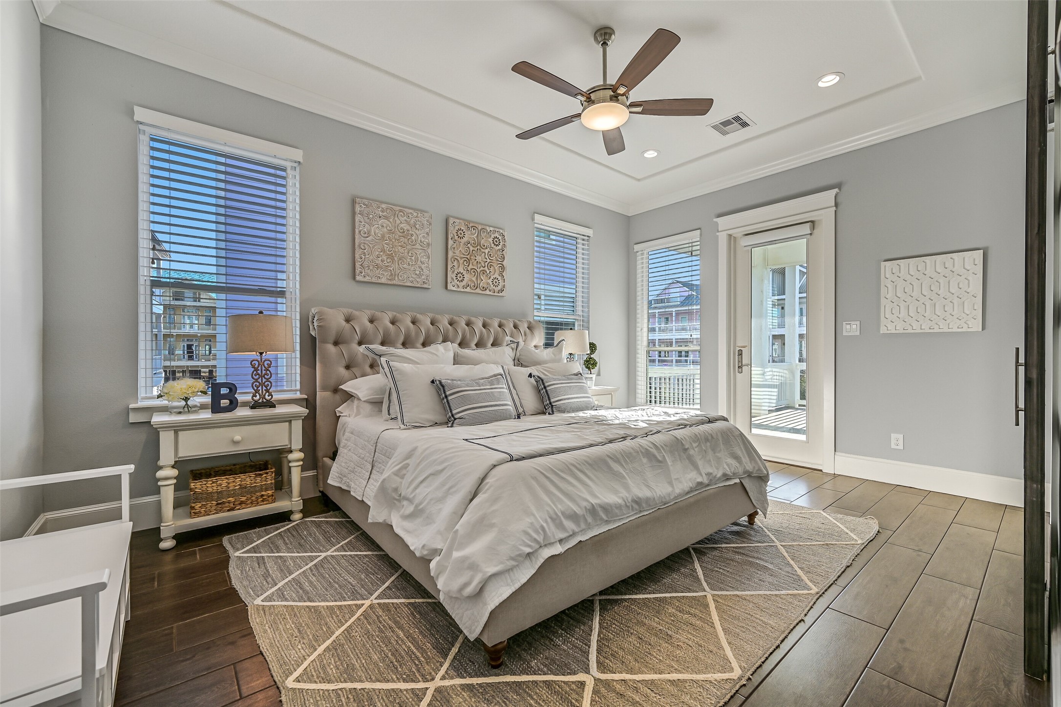 3839 Periwinkle Galveston, TX 77554 - Photo 18 of 49 On the first floor, you’ll find one of two primary bedrooms. This bedroom features abundant natural light, tall ceilings, and access to the private west-facing deck.