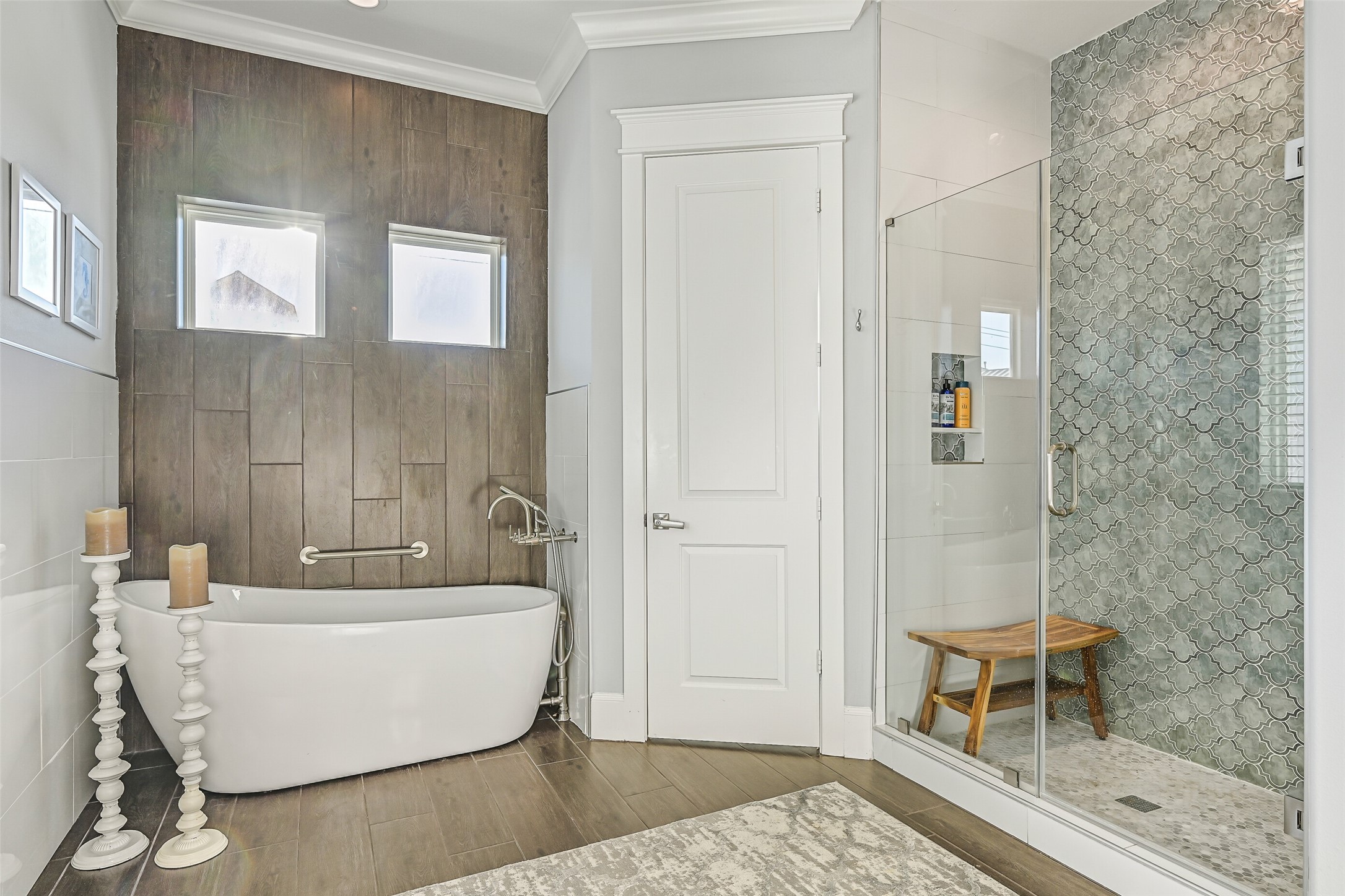3839 Periwinkle Galveston, TX 77554 - Photo 24 of 49 Another view of the bathroom showcasing the soaking tub and shower. Notice how the tile plank flooring flows seamlessly onto the wall behind the tub.