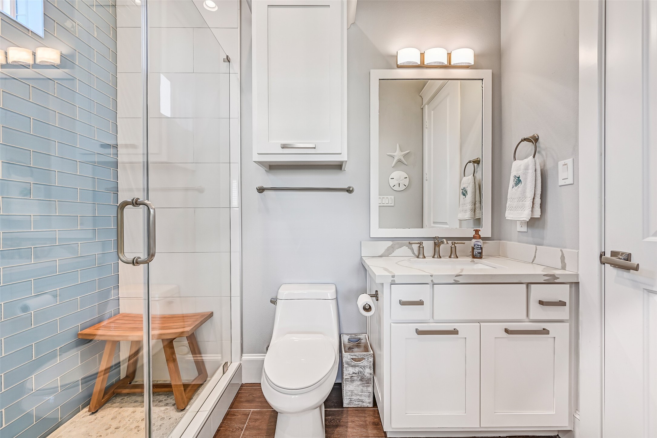 3839 Periwinkle Galveston, TX 77554 - Photo 36 of 49 The en-suite bath offers a standing shower, gorgeous tilting throughout and a quartz countertop.