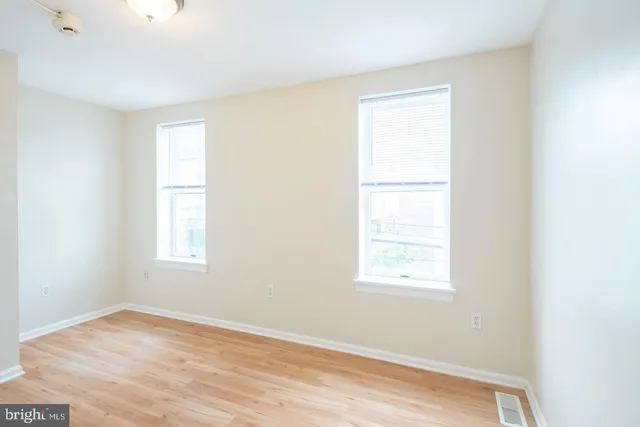 a front view of a building and car parked