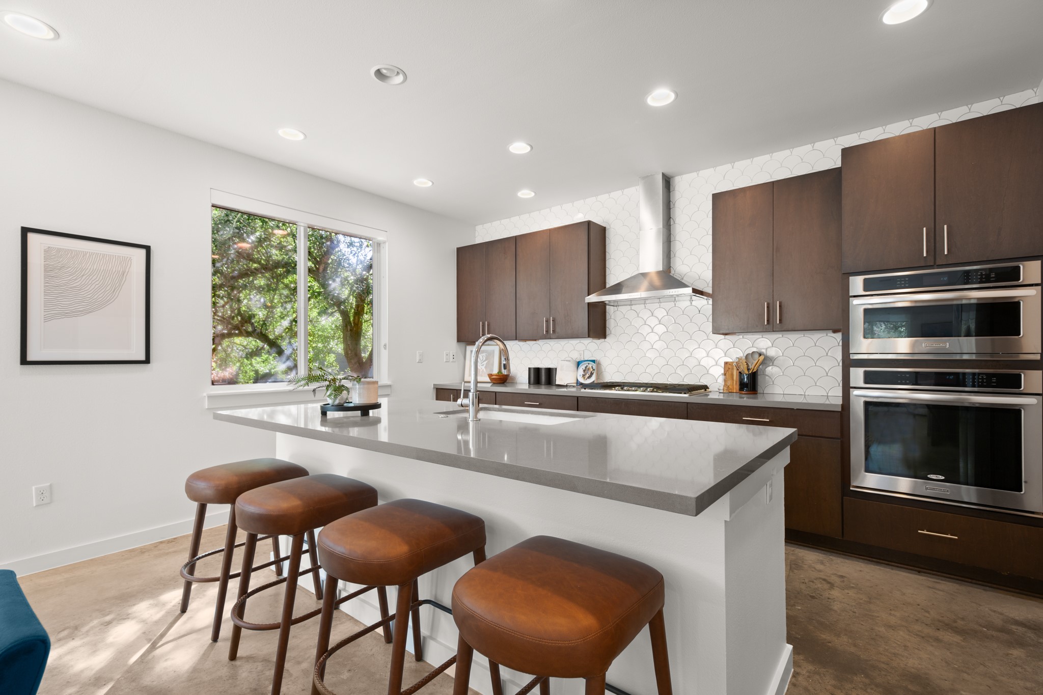 4111 Spicewood Springs Road, Unit 1 Austin, TX 78759 - Photo 10 of 31 This kitchen is a chef’s dream, with stainless steel appliances, a large island, and a neutral backdrop