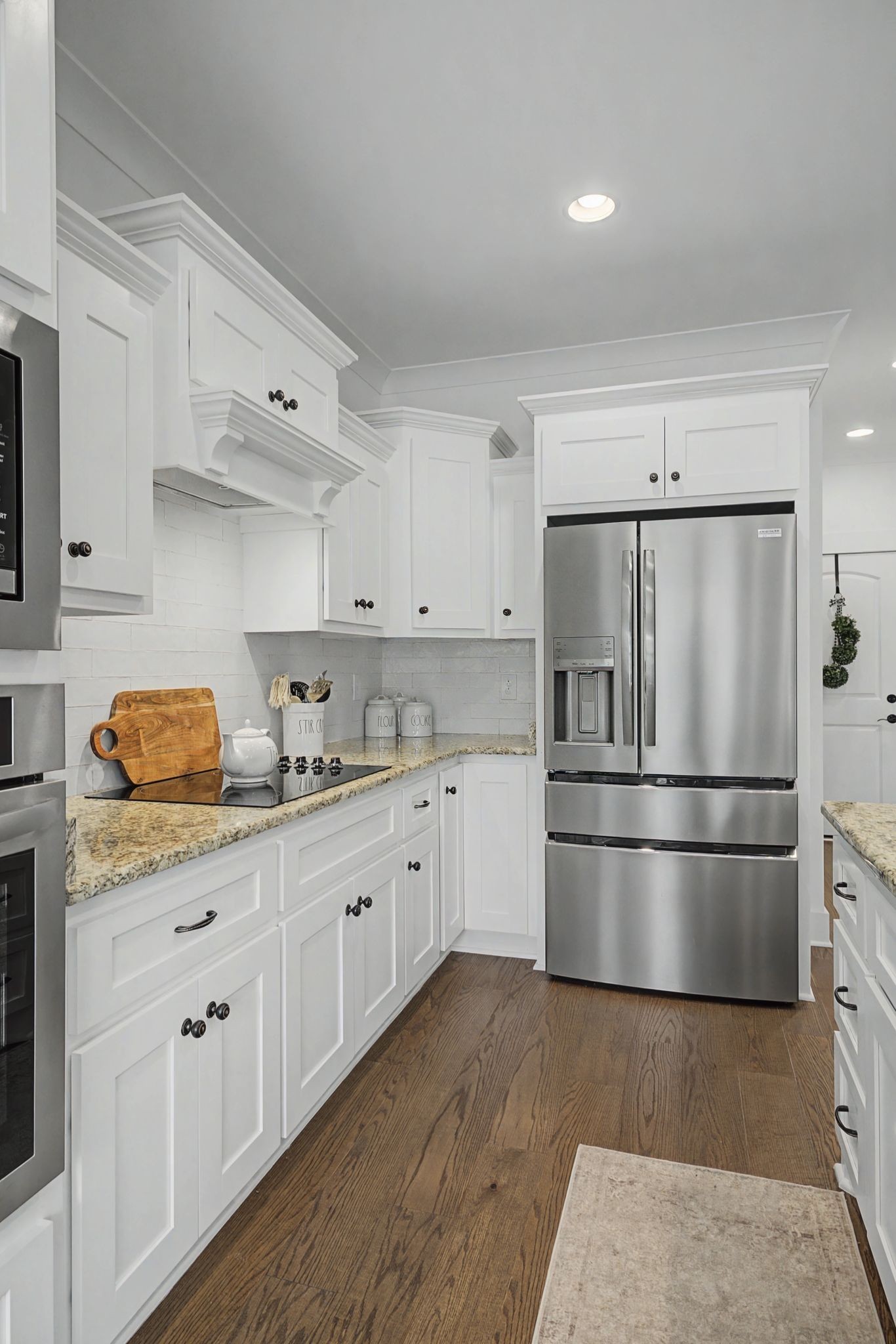 238 Hill Creek Road Woodbury, TN 37190 - Photo 13 of 40 a kitchen with granite countertop white cabinets a refrigerator a sink and dishwasher
