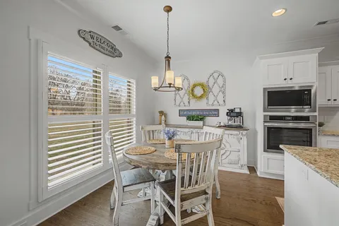 a dining room with furniture and window
