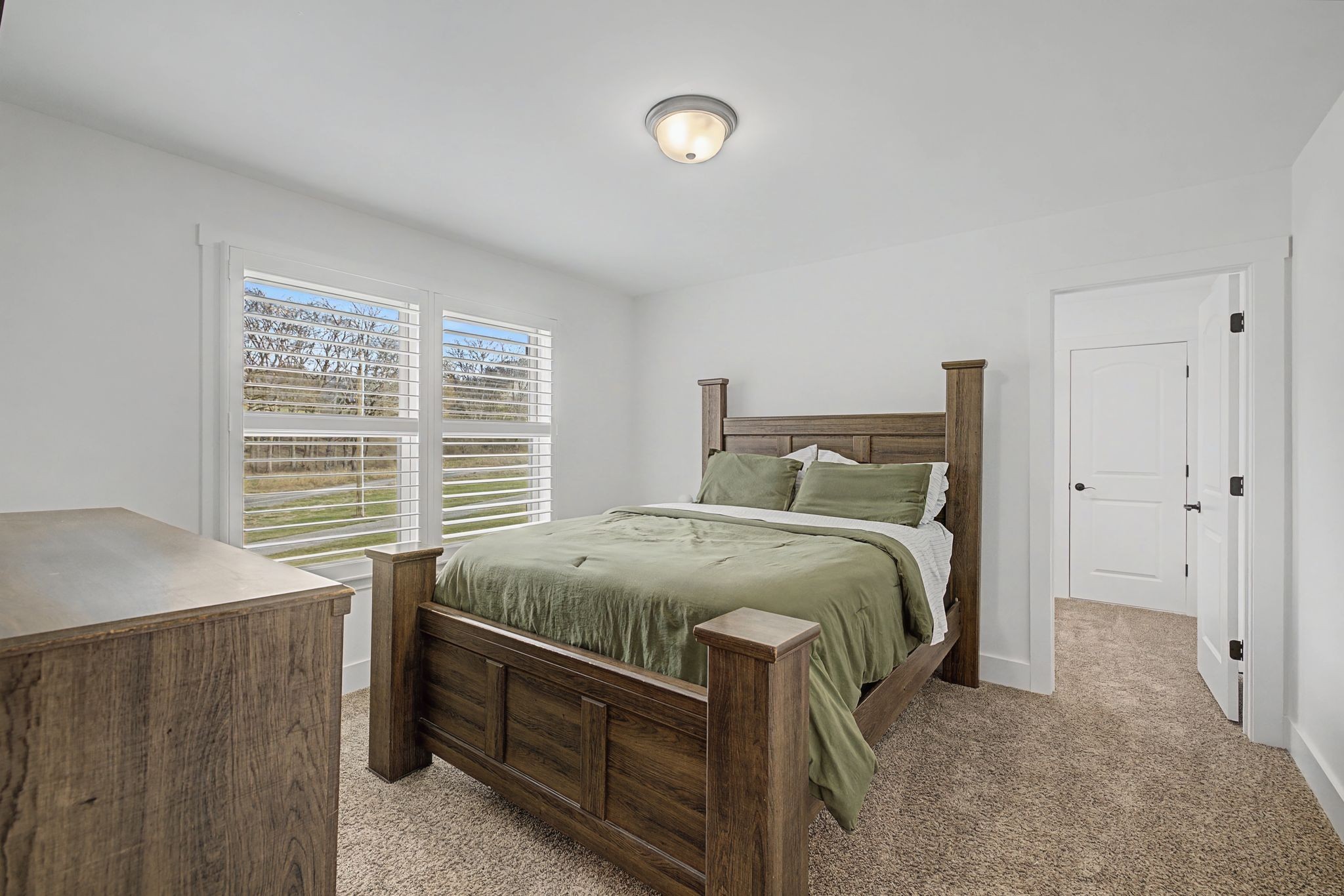 238 Hill Creek Road Woodbury, TN 37190 - Photo 28 of 40 a bed sitting in a bedroom next to a window