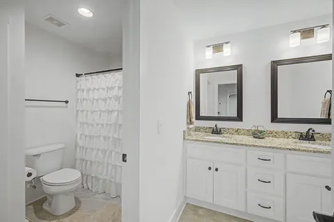 a bedroom with a bed and a tv