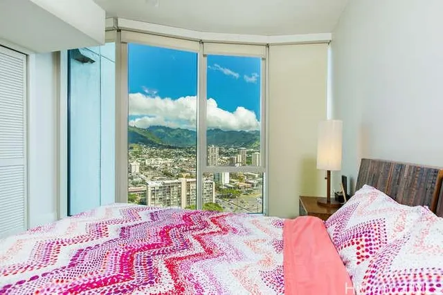 a bedroom with a bed and a large window