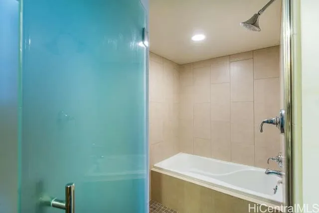 a bathroom with a bathtub and a shower