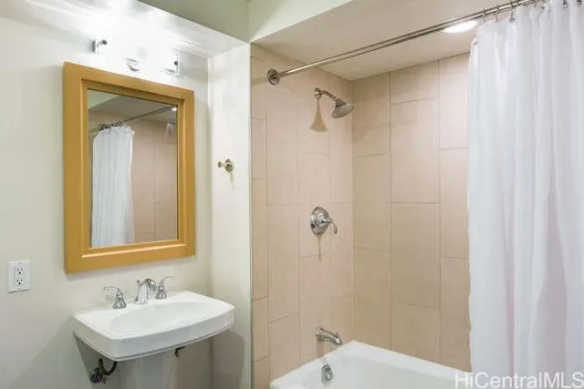 a bathroom with a sink a mirror and a shower