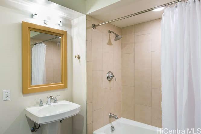 1837 Kalakaua Avenue, Unit 2505 Honolulu, HI 96815 - Photo 8 of 10 a bathroom with a sink a mirror and a shower