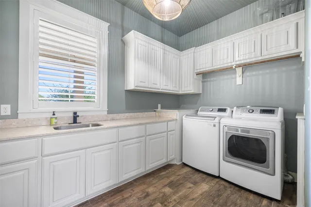 a view of hallway with window and wooden floor