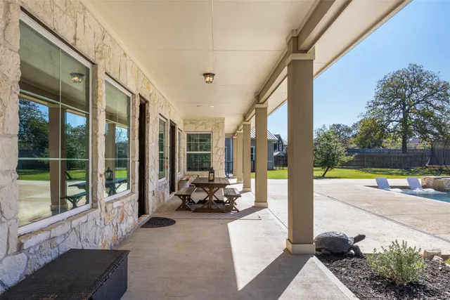 a front view of a house with a garden and patio