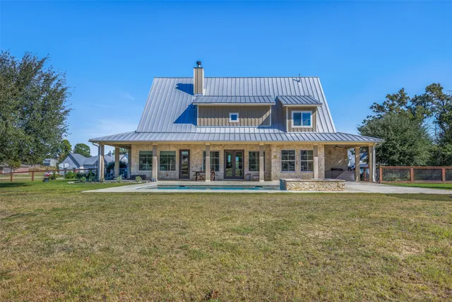 a front view of a house with a garden and deck