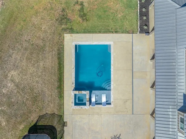 an aerial view of a house with a yard