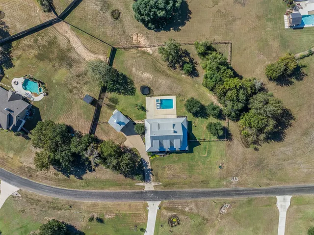 an aerial view of a houses with a yard