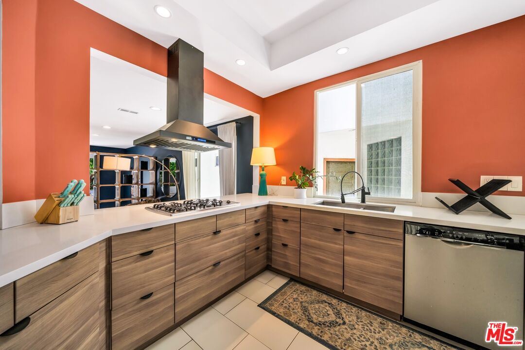 679 Washington Boulevard Marina del Rey, CA 90292 - Photo 12 of 37 a kitchen with stainless steel appliances granite countertop a sink and a stove