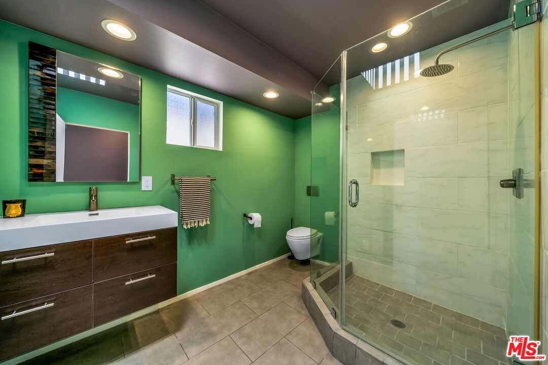 679 Washington Boulevard Marina del Rey, CA 90292 - Photo 30 of 37 a spacious bathroom with a granite countertop sink a toilet and a mirror