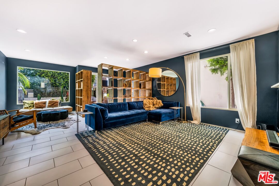679 Washington Boulevard Marina del Rey, CA 90292 - Photo 9 of 37 a living room with furniture a rug and a large window