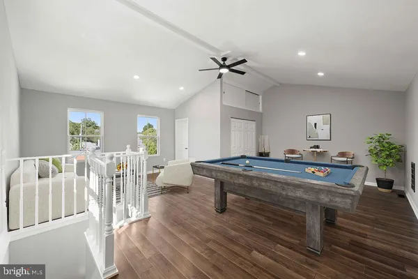 a living room with furniture a table and wooden floor