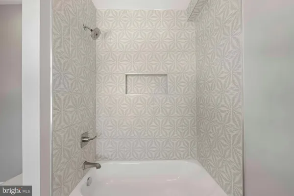 a view of a livingroom with wooden floor and a ceiling fan