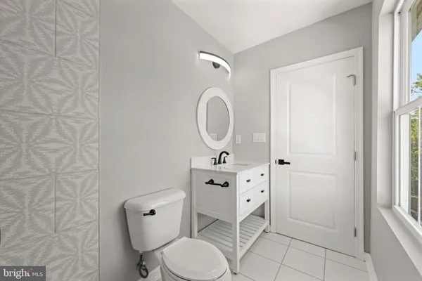 a front view of a house with a garden and deck