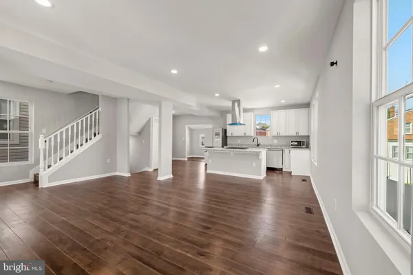 a kitchen with stainless steel appliances granite countertop a sink stove and cabinets