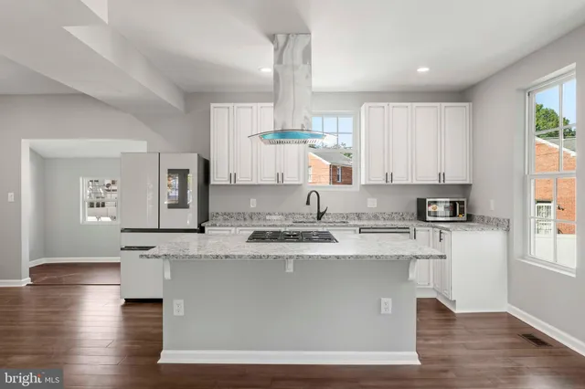a white toilet sitting next to a bathroom sink