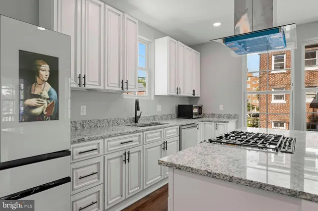 a view of hallway with wooden floor