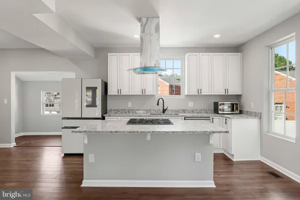 a white toilet sitting next to a bathroom sink