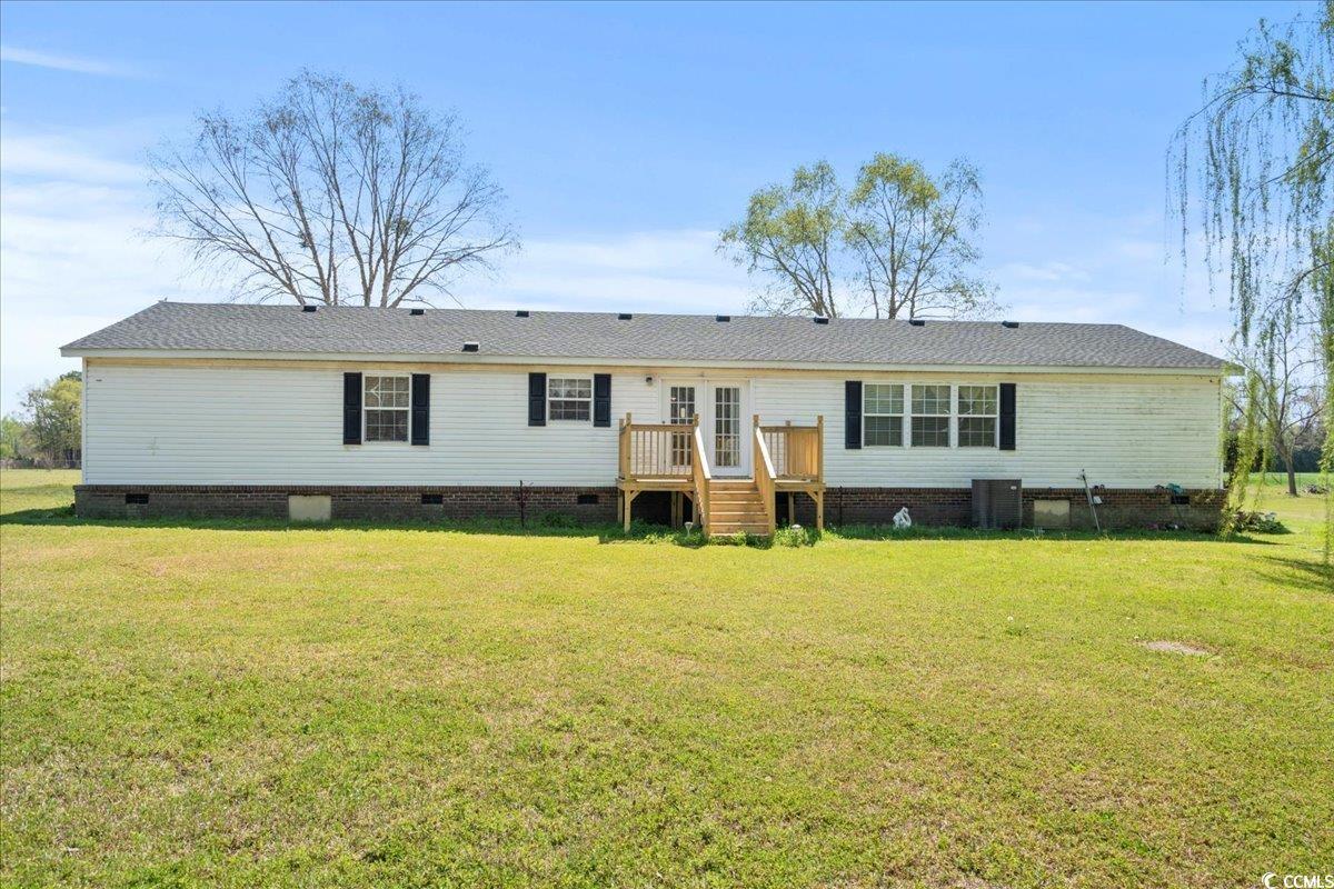 1130 Buck Swamp Road Fork, SC 29543 - Photo 25 of 35 View of front of home featuring a wooden deck, french doors, crawl space, central AC unit, and a front yard