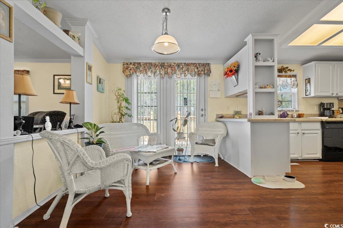 1130 Buck Swamp Road Fork, SC 29543 - Photo 7 of 35 Interior space with a textured ceiling, ornamental molding, and dark wood finished floors
