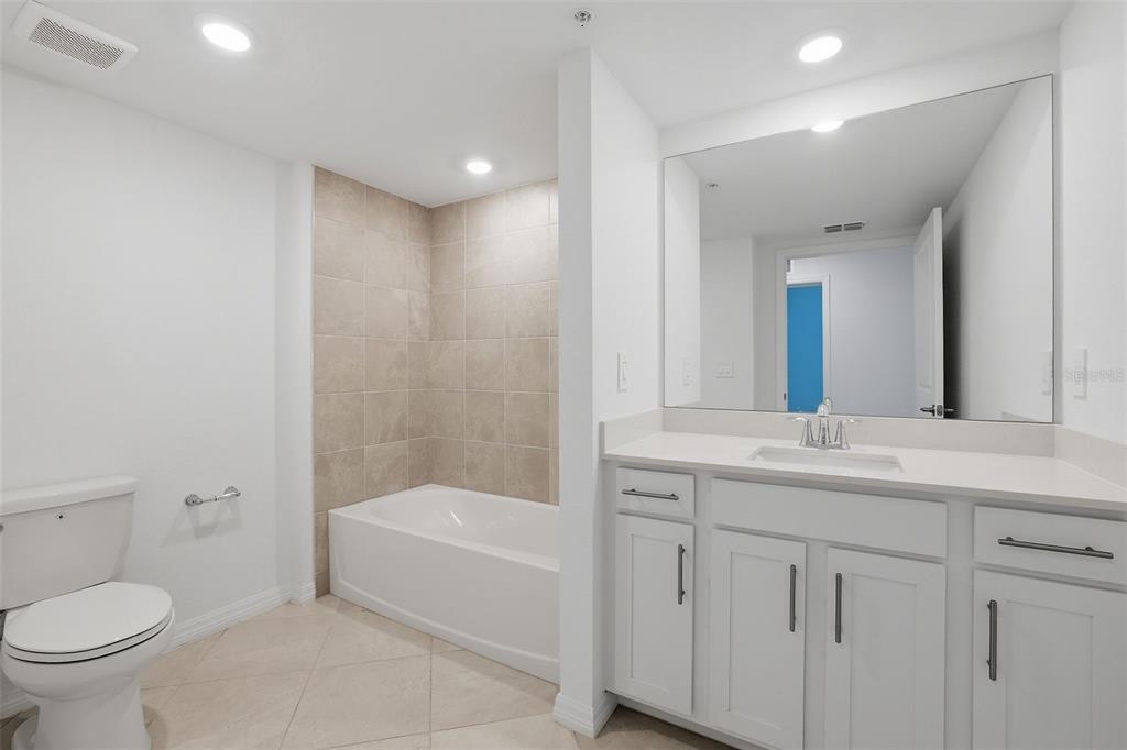 19227 Cherrystone Way, Unit 101 Lakewood Ranch, FL 34211 - Photo 14 of 19 a bathroom with a toilet sink and bathtub