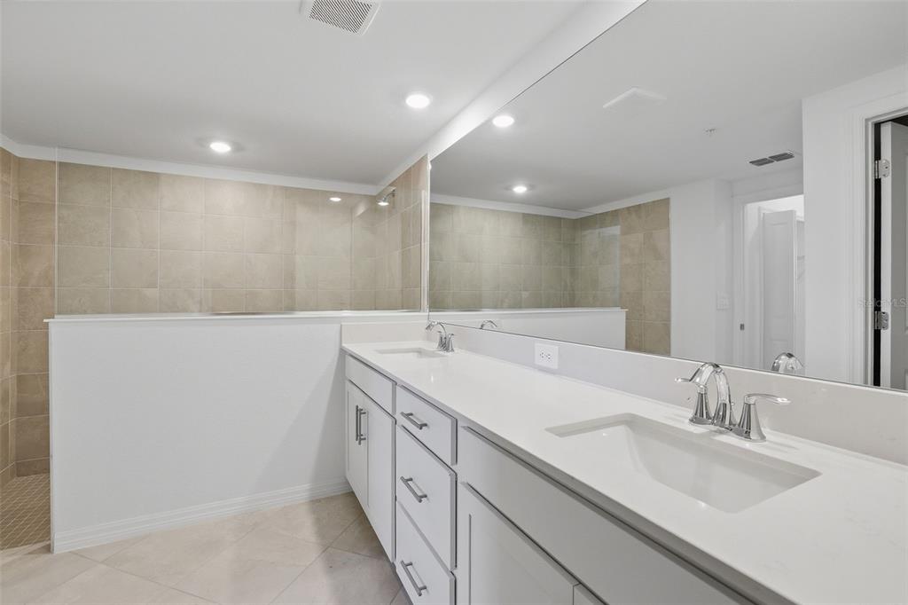 19227 Cherrystone Way, Unit 101 Lakewood Ranch, FL 34211 - Photo 15 of 19 a bathroom with a double vanity sink and a mirror