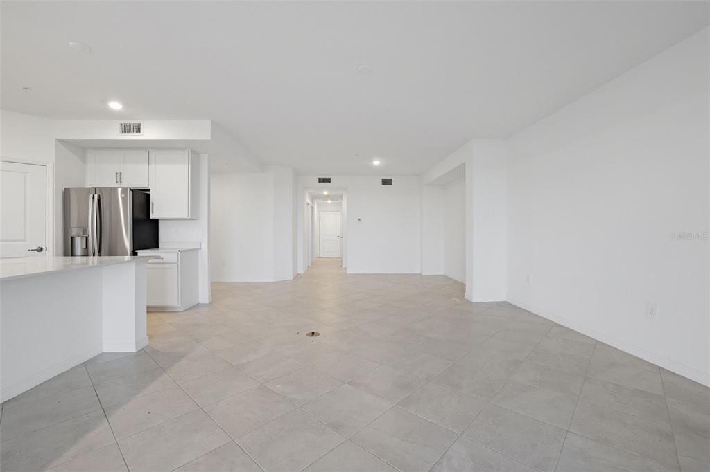 19227 Cherrystone Way, Unit 101 Lakewood Ranch, FL 34211 - Photo 6 of 19 a view of a kitchen with refrigerator and a sink