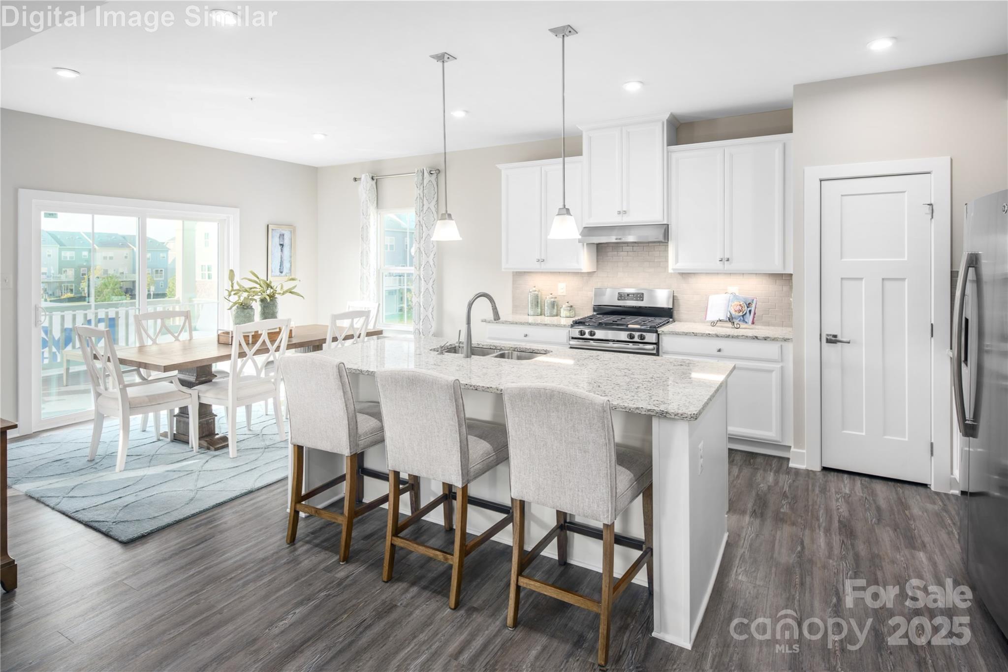 6334 Durango Way Denver, NC 28037 - Photo 2 of 22 a kitchen with stainless steel appliances granite countertop a stove a refrigerator a kitchen island a dining table and chairs with wooden floor