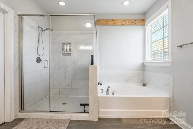 a living room with furniture a flat screen tv and a window