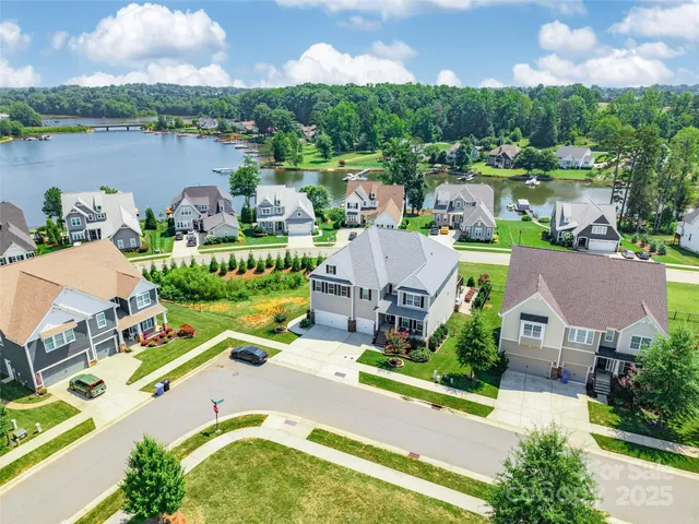 an aerial view of a house with outdoor space and lake view