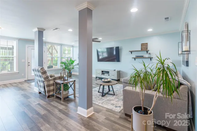 a living room with furniture and wooden floor