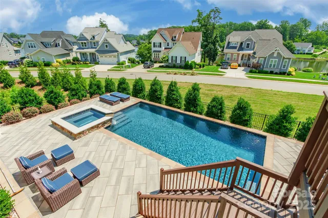 a view of swimming pool with a yard and plants