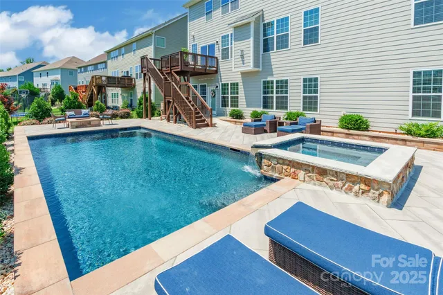 a view of swimming pool with outdoor seating and plants